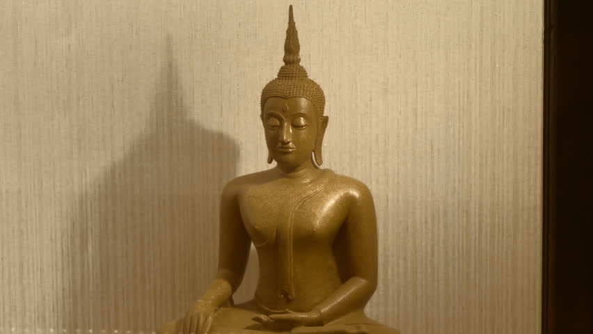 Metal statues of The Buddha stand next to each other covered from dust and moist with plastic covers inside Wiharn Phra Mongkhon Bophit temple in Ayutthaya known for its massive, gilded statue of the 