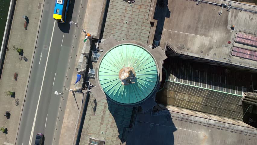 Overhead rising aerial video of Custom House Quay in Dublin, County Leinster, Ireland on a bright and sunny day. Filmed in 4K, 60FPS and with Rec709 color.