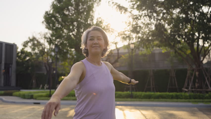 Asia adult aged people middle age mindful happy old woman yoga body pose zen calm stress relief outdoor nature public park sun light self love relax elder aging life asian female mental health care.