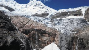 Aerial rises over mountain peak glacial waterfalls on rock cliff, Peru - Powered by Shutterstock - Get 15% off with code: PIKWIZARD15