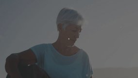 Elderly woman using downward gaze, activating glowing nodes and mapping health network at beach. Gerontology, mindfulness, connectivity, serenity, digital interface, wellness, relaxation - Powered by Shutterstock - Get 15% off with code: PIKWIZARD15