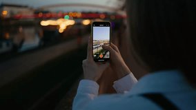 Woman with smartphone capturing city alone during dusk, loneliness reflected in glowing river lights, loneliness echoing through empty frame, loneliness wrapped in urban stillness. Solitude and woman - Powered by Shutterstock - Get 15% off with code: PIKWIZARD15