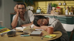 African American man Latina Arabian woman girl guy friends high school university students tired exhausted sleeping at home kitchen napping sleep lying books boring studying homework fatigue overwork - Powered by Shutterstock - Get 15% off with code: PIKWIZARD15