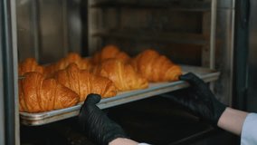 Baker removes tray of hot croissants from oven - Powered by Shutterstock - Get 15% off with code: PIKWIZARD15