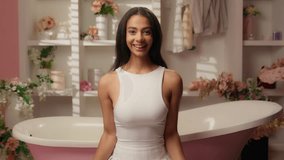 Hispanic Latina woman smiling excited girl teen female beauty influencer in bathroom prepare choose clothes accessories pink bag and boots fashion style glamour online shopping store sales discount - Powered by Shutterstock - Get 15% off with code: PIKWIZARD15
