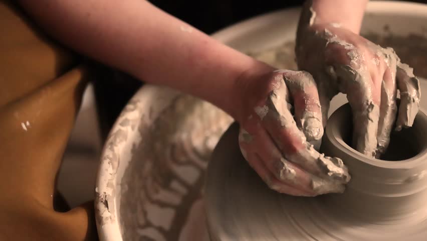 Close-up of hands working with clay on a pottery wheel in an artisan studio. Creative hobby, hands-on ceramic art and mindful handmade craftsmanship.