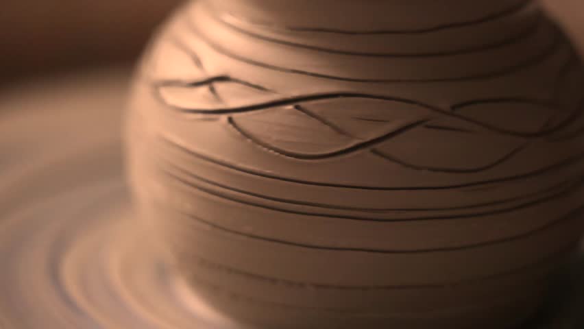 Close-up of hands working with clay on a pottery wheel in an artisan studio. Creative hobby, hands-on ceramic art and mindful handmade craftsmanship.
