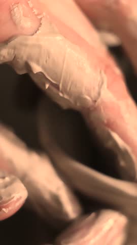 Close-up of hands working with clay on a pottery wheel in an artisan studio. Creative hobby, hands-on ceramic art and mindful handmade craftsmanship.