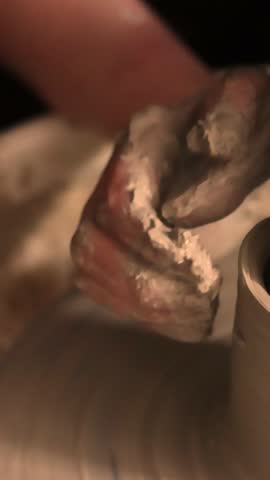 Close-up of hands working with clay on a pottery wheel in an artisan studio. Creative hobby, hands-on ceramic art and mindful handmade craftsmanship.