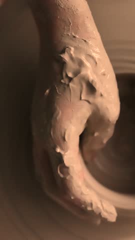 Close-up of hands working with clay on a pottery wheel in an artisan studio. Creative hobby, hands-on ceramic art and mindful handmade craftsmanship.