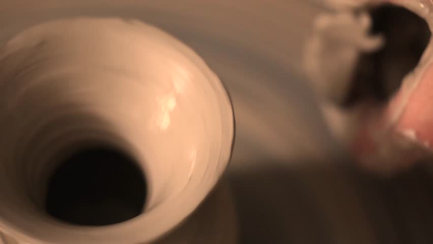 Close-up of hands working with clay on a pottery wheel in an artisan studio. Creative hobby, hands-on ceramic art and mindful handmade craftsmanship.