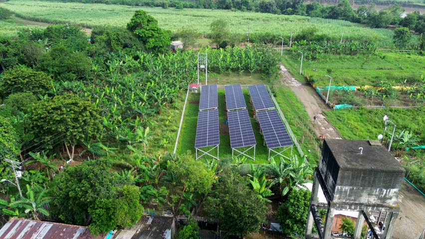 Aerial shot of renewable energy village with sustainable farming. High quality 4k footage
