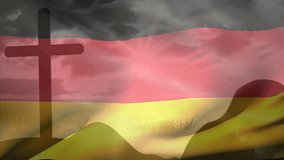 German flag catching breeze over grassy hills by cross showing billowing folds to evoke solemn mood. Symbol, patriotism, landscape, movement, silhouette, fabric, memorial - Powered by Shutterstock - Get 15% off with code: PIKWIZARD15