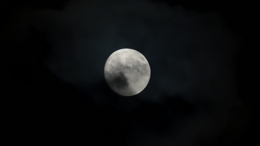 View at full moon at cloudy night sky. Scary atmosphere. Close up shot