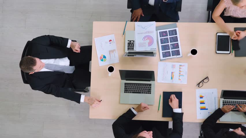 Successful business people celebrate together with joy at office table shot from top view . Young businessman and businesswoman workers express cheerful victory showing success by teamwork . - Powered by Shutterstock - Get 15% off with code: PIKWIZARD15