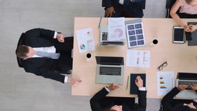 Successful business people celebrate together with joy at office table shot from top view . Young businessman and businesswoman workers express cheerful victory showing success by teamwork . - Powered by Shutterstock - Get 15% off with code: PIKWIZARD15