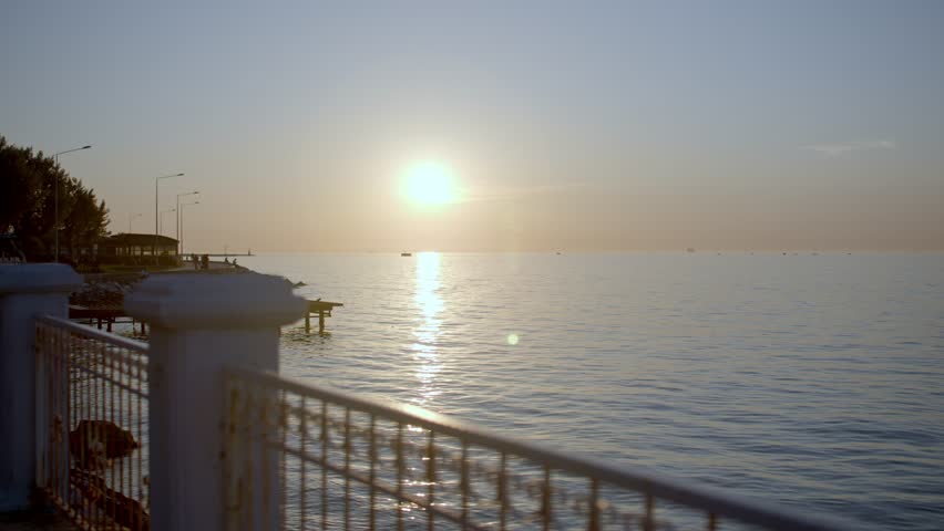 Sunset Over the Sea with Seaside Promenade and Iron Fence in Turkey