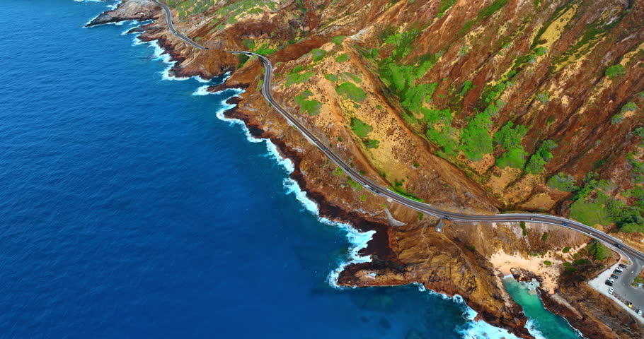 Highway built on the rocky shore of the Pacific Ocean. Spectacular scenery of the Diamond Head Crater in Hawaii, USA. Aerial view.