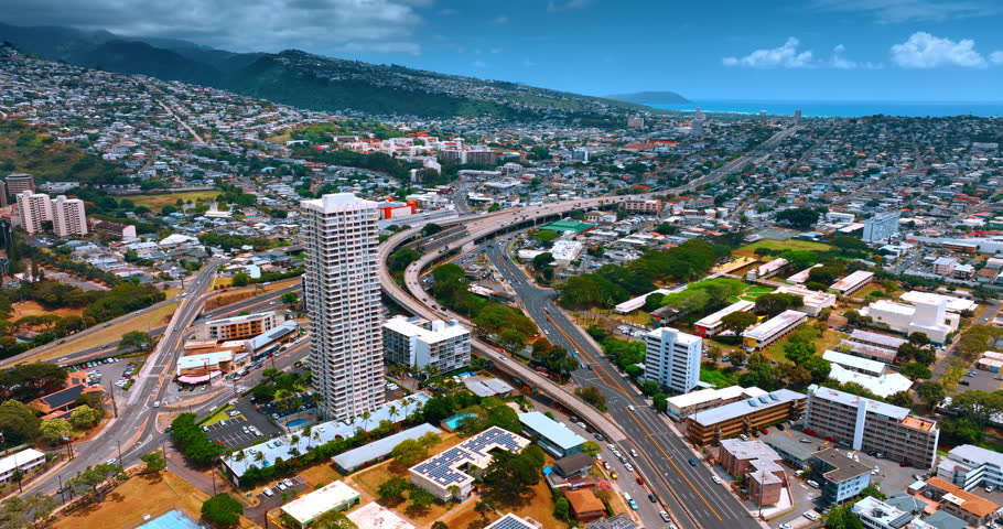 View on the highways crossing the cityscape of Honolulu, Hawaii, USA. Sunny lively modern city from top perspective.