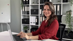 Business woman working laptop happy smiling looking at camera in office positive adult businesswoman success good job look portrait middle-aged female manager typing computer task at workplace smile - Powered by Shutterstock - Get 15% off with code: PIKWIZARD15