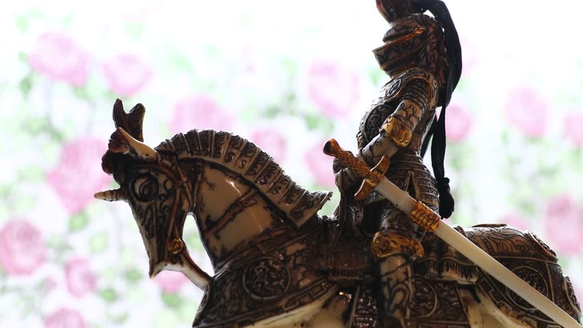 figurine knight in armor on horseback.