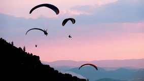 Paragliders Gliding Over Mountain Trail at Festival - Powered by Shutterstock - Get 15% off with code: PIKWIZARD15