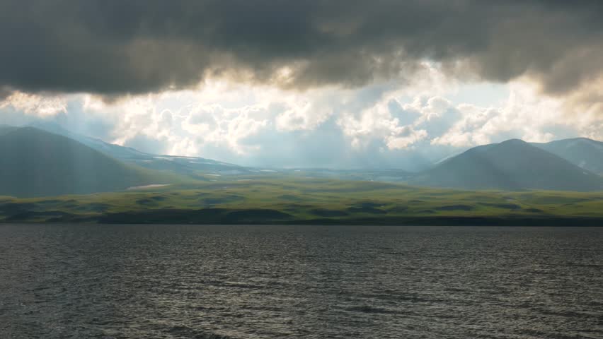 Breathtaking view of mountains and lake under cloudy sky