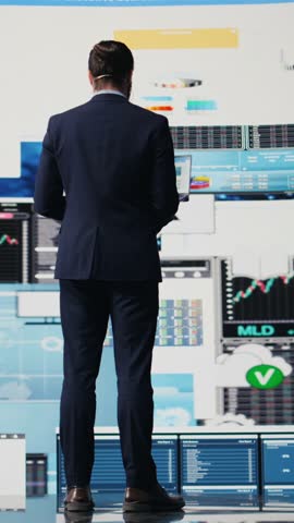 Vertical Video Visionary business leader gives detailed business pitch using data and graphs in a packed public speaking event. Audience listening as the CEO expert shares growth and success insight
