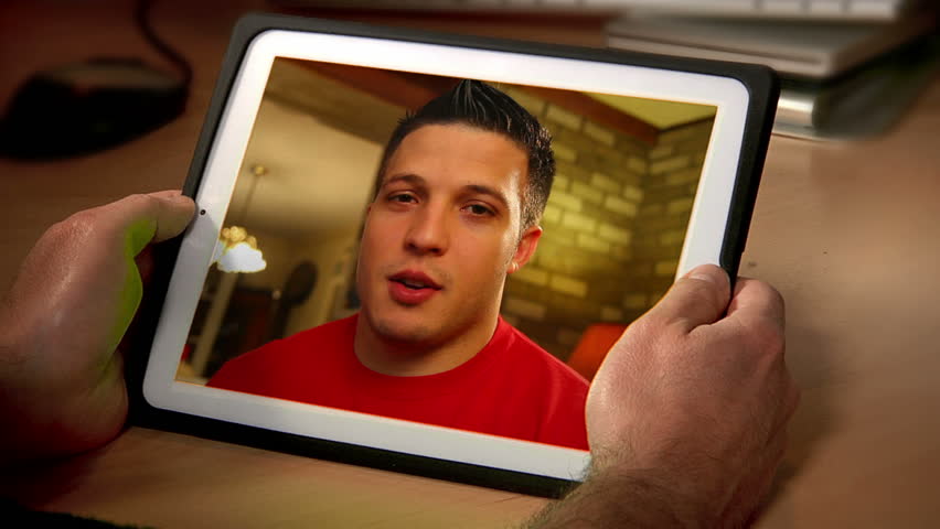 A man videochats on a tablet.