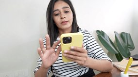 Closeup of 30s pretty young Asian woman sits on chair at workspace desk in office or home holding using smart phone distance chatting communicating online networks social media app. - Powered by Shutterstock - Get 15% off with code: PIKWIZARD15
