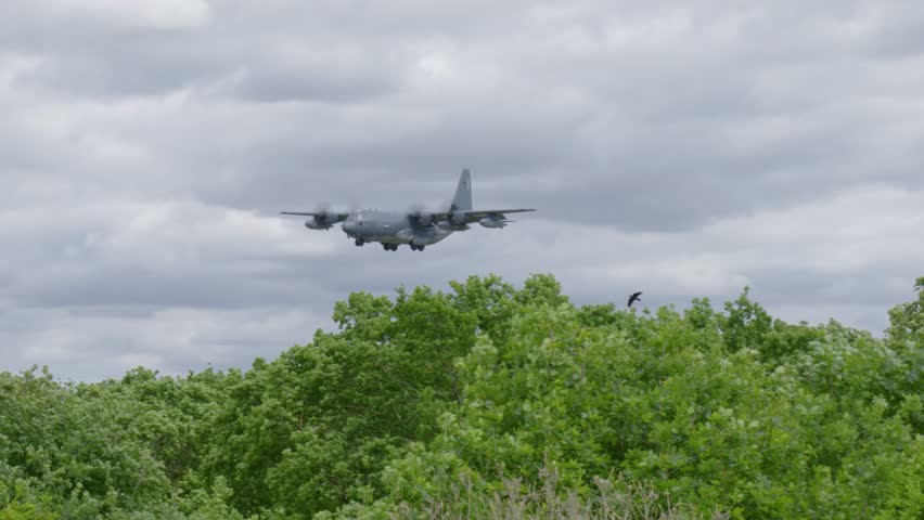Large grey military aircraft flying low near Royal Air Force Mildenhall, UK base