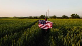 Young happy woman with American flag in a wheat field at sunset celebrate Independence day. 4th of July. Patriotic holiday, american day. Independence Day. - Powered by Shutterstock - Get 15% off with code: PIKWIZARD15
