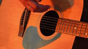 Close-Up of Hands Playing Acoustic Guitar in Warm Lighting - Powered by Shutterstock - Get 15% off with code: PIKWIZARD15