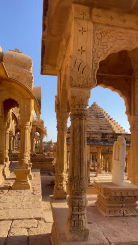 A close-up view of Jaisalmer's Bada Bagh on a bright desert day, where Rajasthan’s majestic architecture and stone carvings glow under the sunny sky India 4K