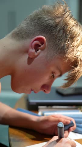 Teen sketches intently with a marker, focused on their art project