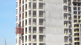 Construction site of modern high-rise building with scaffolding, hoist, and safety nets. Concrete structure rising in an urban environment - Powered by Shutterstock - Get 15% off with code: PIKWIZARD15