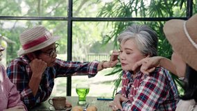 asian senior woman gently touching friend's face in supportive caring gesture during relaxing retirement moment in cozy cafe showing strong friendship, warmth, and emotional bonding - Powered by Shutterstock - Get 15% off with code: PIKWIZARD15
