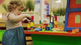 Child builds with colorful blocks in a playful learning environment during midday - Powered by Shutterstock - Get 15% off with code: PIKWIZARD15
