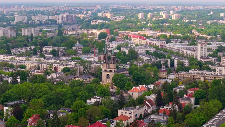 Drone orbits around Saint Stanislaus Kostka Church and Wilson Square in Warsaw, establishing overview