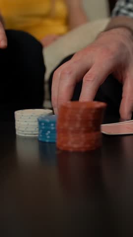 Leisure, games, friendship, gambling and entertainment - Hands with poker playing cards and chips. Whiskey and cola drinks Vertical shot.