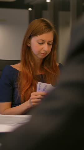 Positive woman employee counting money euro bills, budget banknotes at modern office. Middle slow motion shot. Vertical shot.