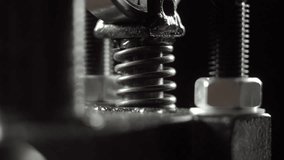 Vertical press spring compresses and decompresses repeatedly. Macro view shows shiny coils and metal bolts with dark blurred background. - Powered by Shutterstock - Get 15% off with code: PIKWIZARD15
