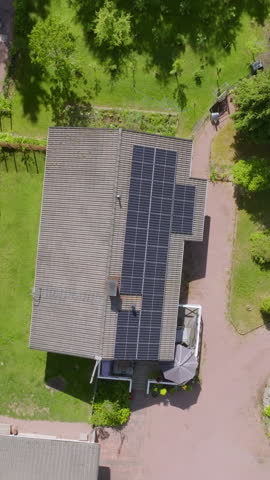 Screwdriver vertical aerial above a solar powered house in lush greenery