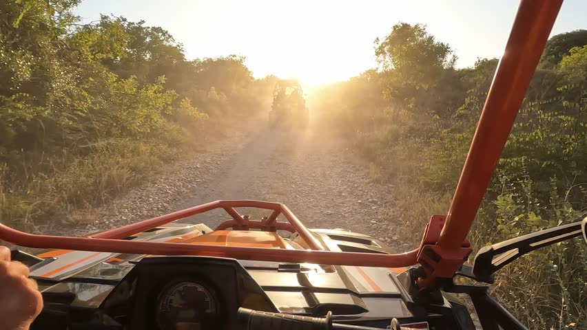 Men tourist having fun during summer buggy tour at sunset - Travel, vacation and wild experience concept 
