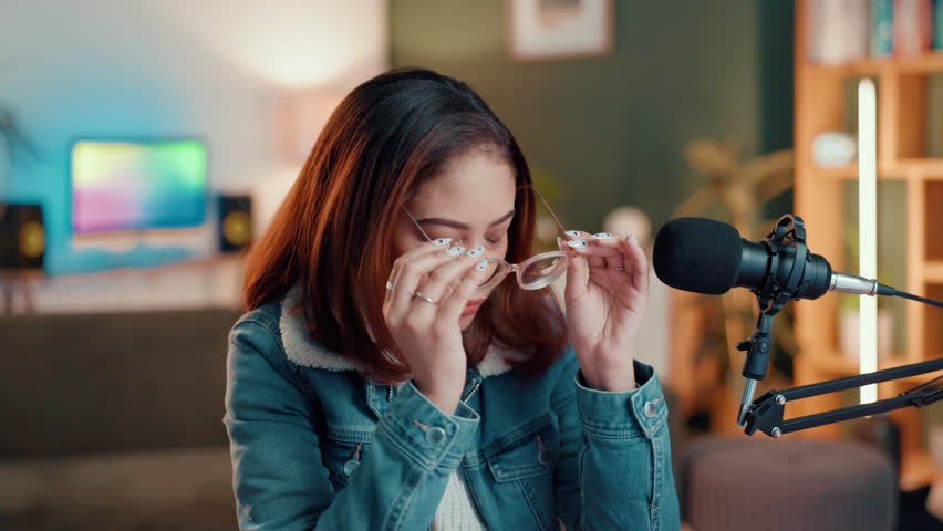 Headache, eye strain and podcast with woman in home for editing deadline, fatigue and overworked. Vision, content creation burnout and migraine with person in studio for streamer, glasses and stress