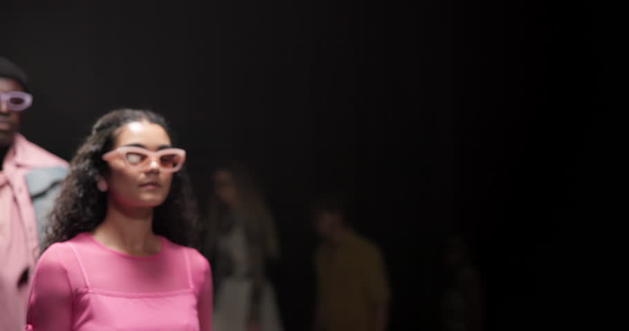 Fashion, catwalk and walking with model at runway event for design collection, showcase and couture. Clothing, wardrobe and luxury show with people on stage for trendy, aesthetic and style industry