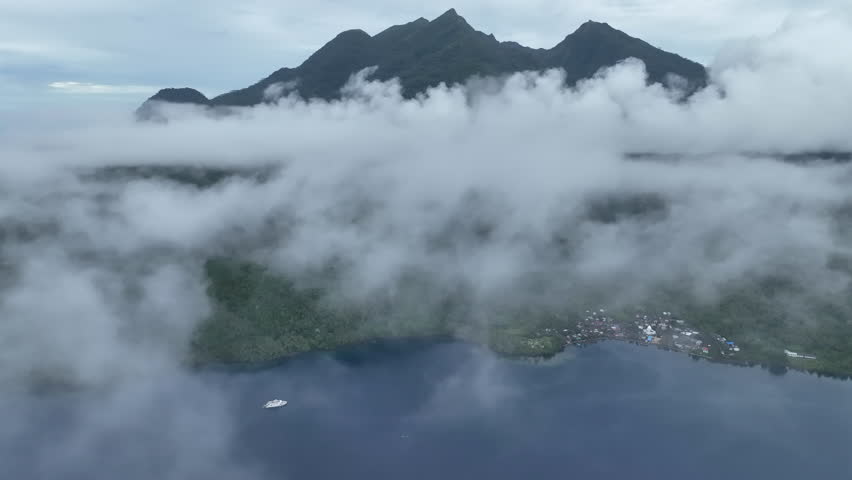 Low clouds enshroud the volcanic island of Mokian just off the west coast of Halmahera in Indonesia. This tropical region is known for its spectacular biodiversity.