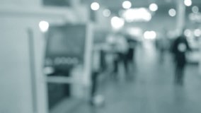 People walking in building with machines and equipment with control panels. Building with walls, floor, ceiling illuminated lamps. Silhouettes of people indoors. Blue color. Blurred background. - Powered by Shutterstock - Get 15% off with code: PIKWIZARD15