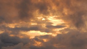 The sun's disk shines through stratus cumulus clouds in the evening sky at golden hour aurora, changeable weather - Powered by Shutterstock - Get 15% off with code: PIKWIZARD15