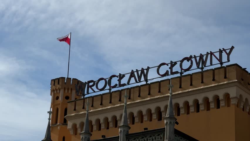 Wroclaw Glowny main railway station building with Polish flag waving on top